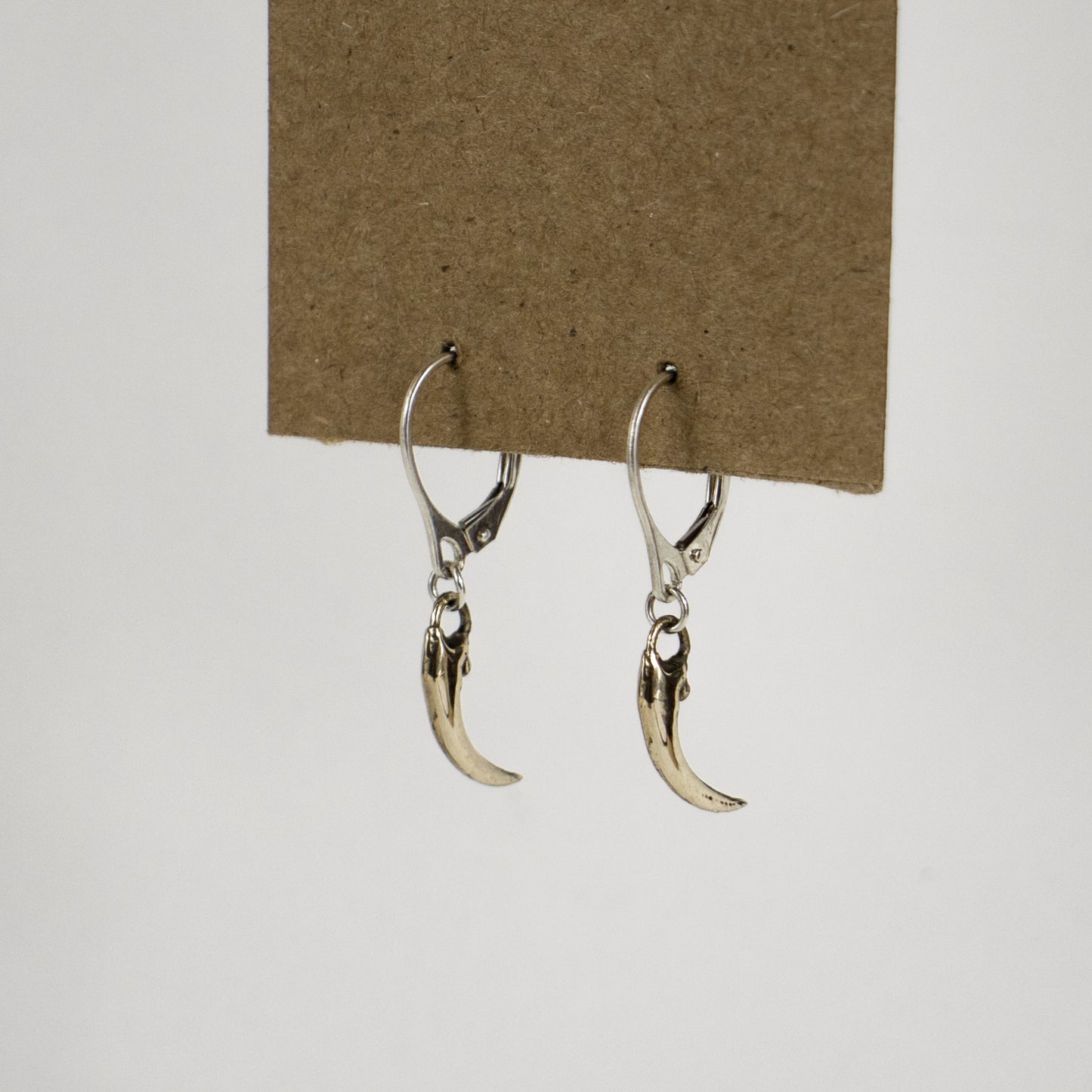 Solid reclaimed sterling silver or brass Icelandic 0.75 inch owl claws on sterling hoops finished in our Catskills store-studio and available as singles to mix-and-match.