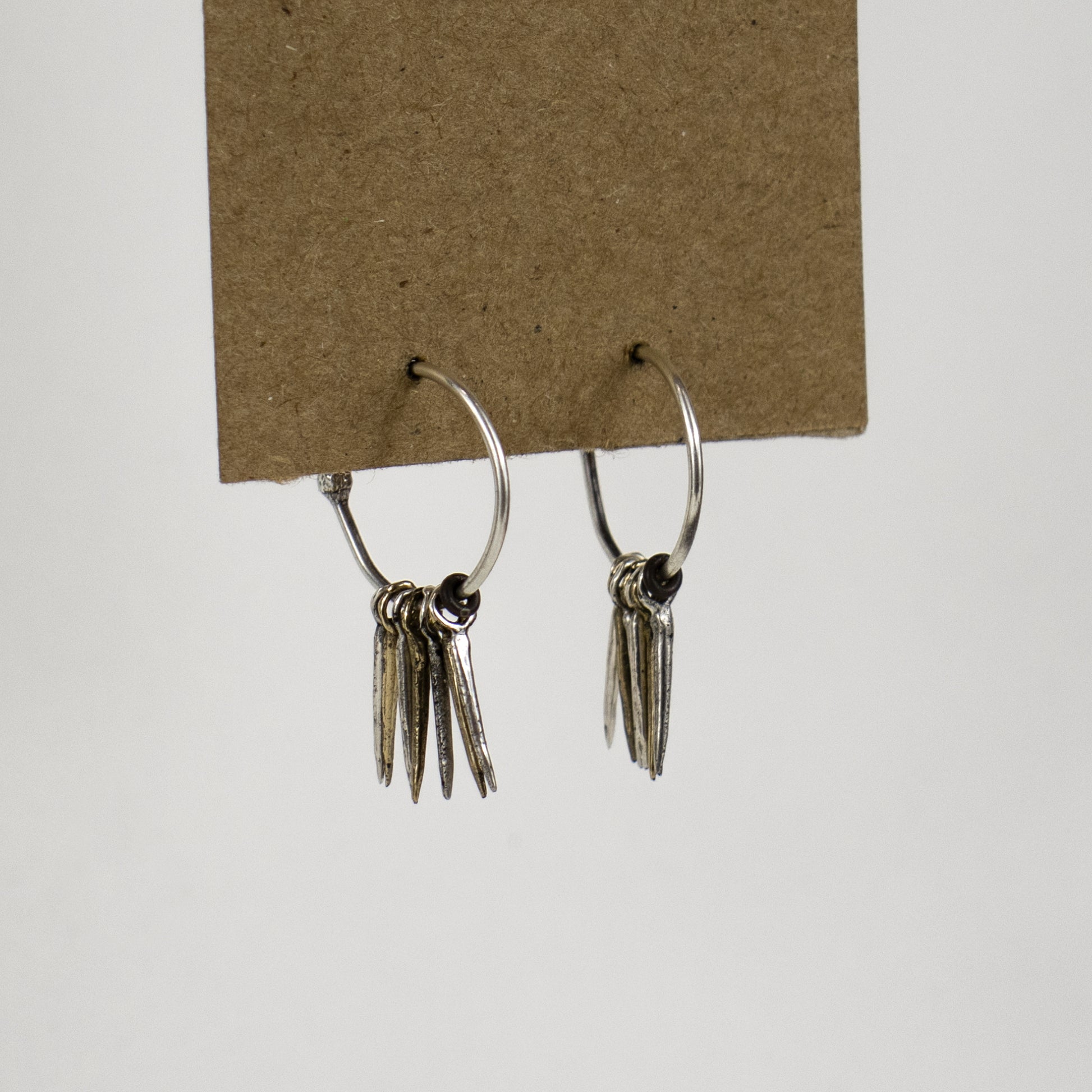 Four reclaimed sterling silver and three brass 0.5 inch snake spikes on sterling hoops and post handmade and finished in our Catskills store-studio and available as singles to mix-and-match.
