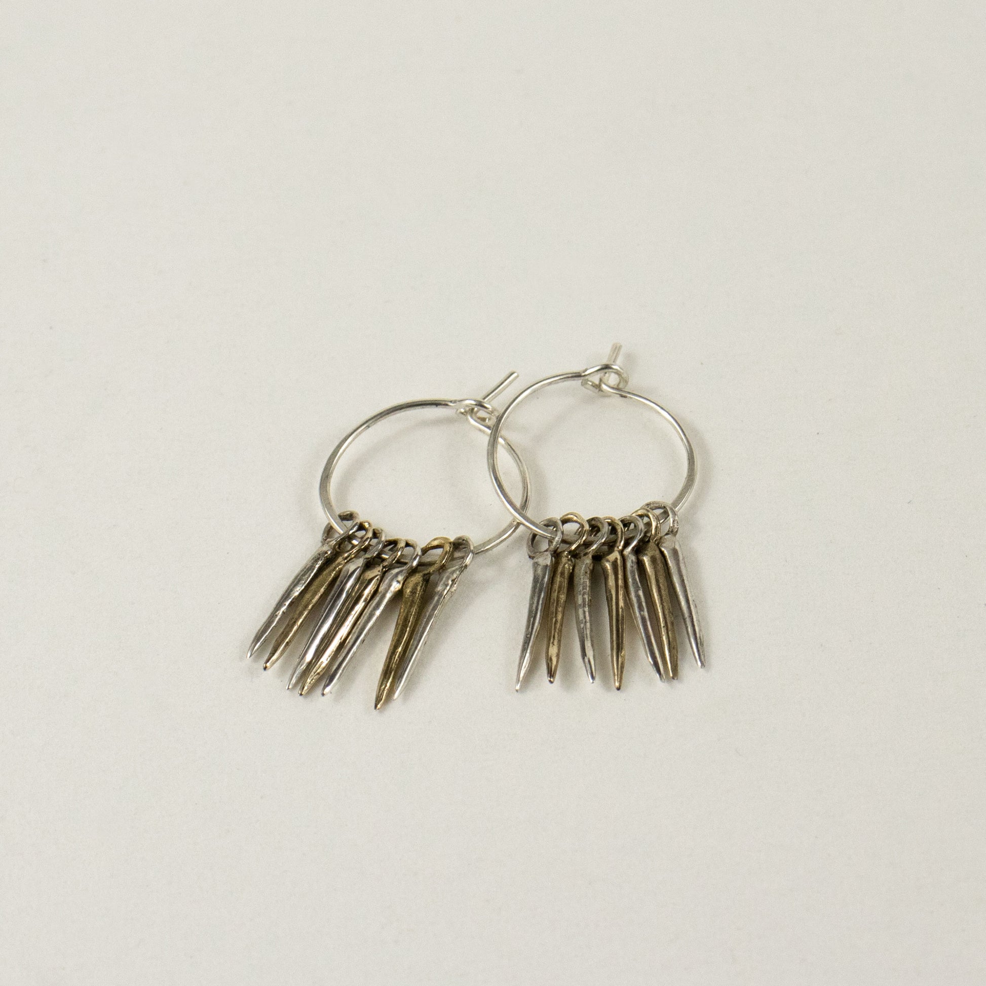 Four solid reclaimed sterling silver and three brass 0.5 inch snake-spikes on handmade sterling hoops handmade and finished in our Catskills store-studio and available as singles to mix-and-match