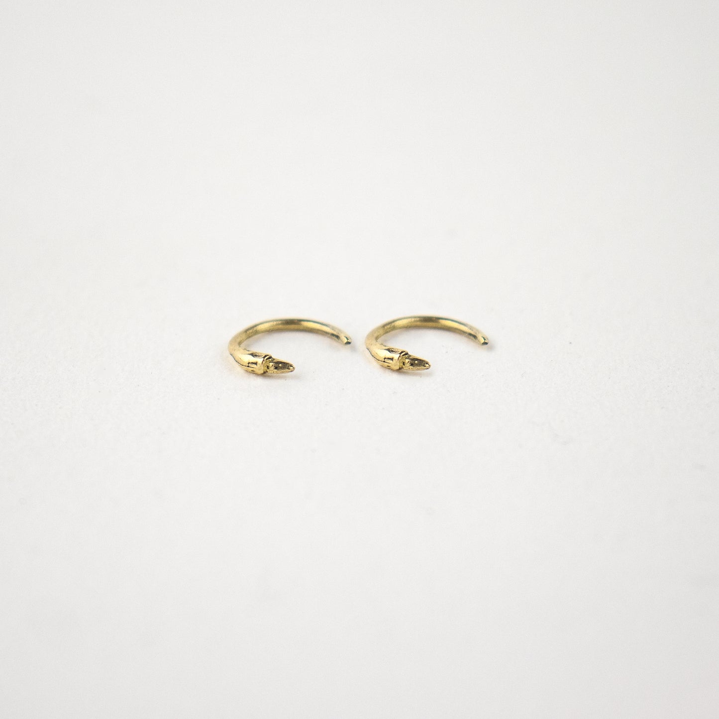 Solid reclaimed tiny 10k gold branch hug earrings handmade and finished in our Catskills store-studio and available as singles to mix-and-mat