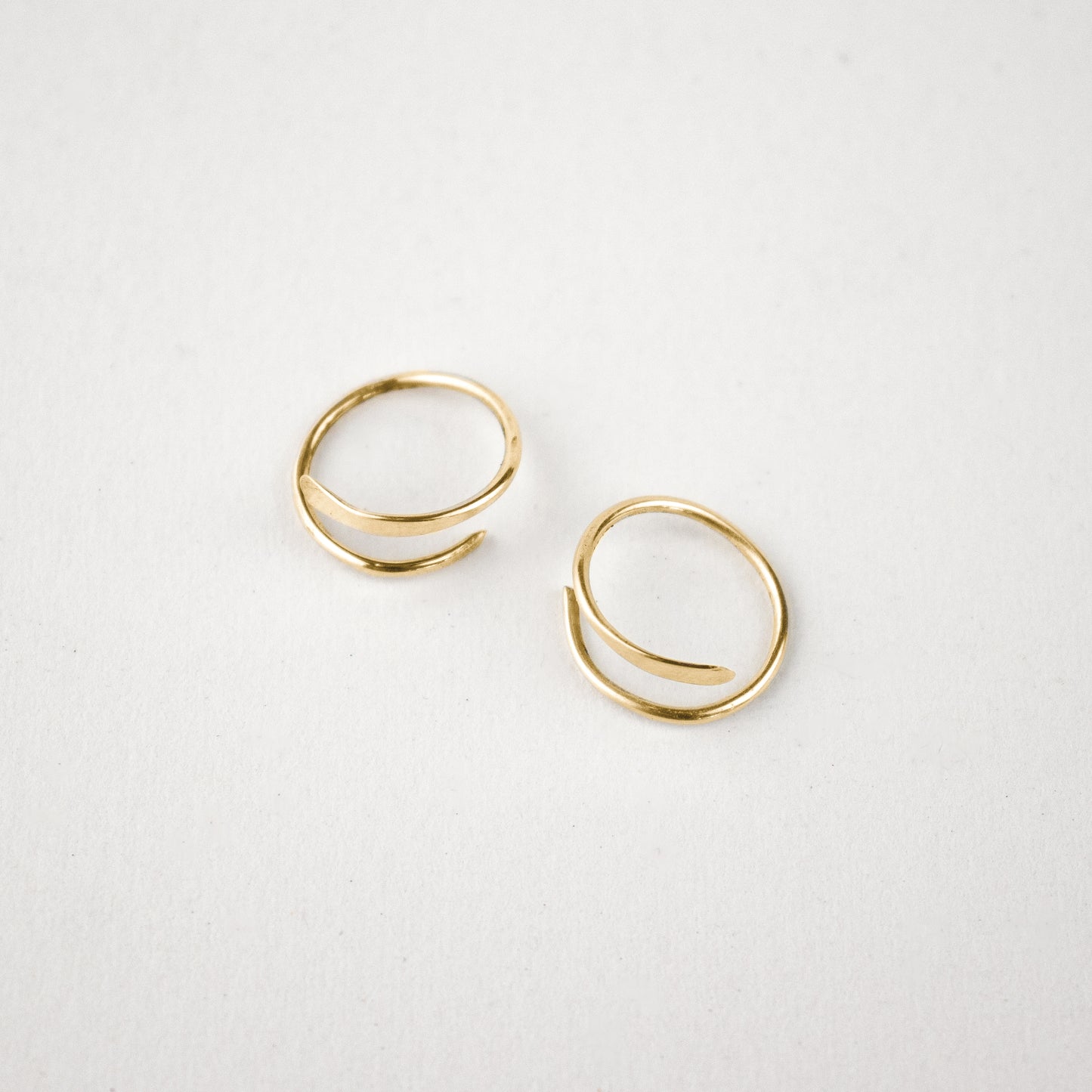 Solid reclaimed 10k gold spiral hoops 0.75 in diameter, hammer-finished in our Catskills store-studio, and available as singles to mix-and-match.