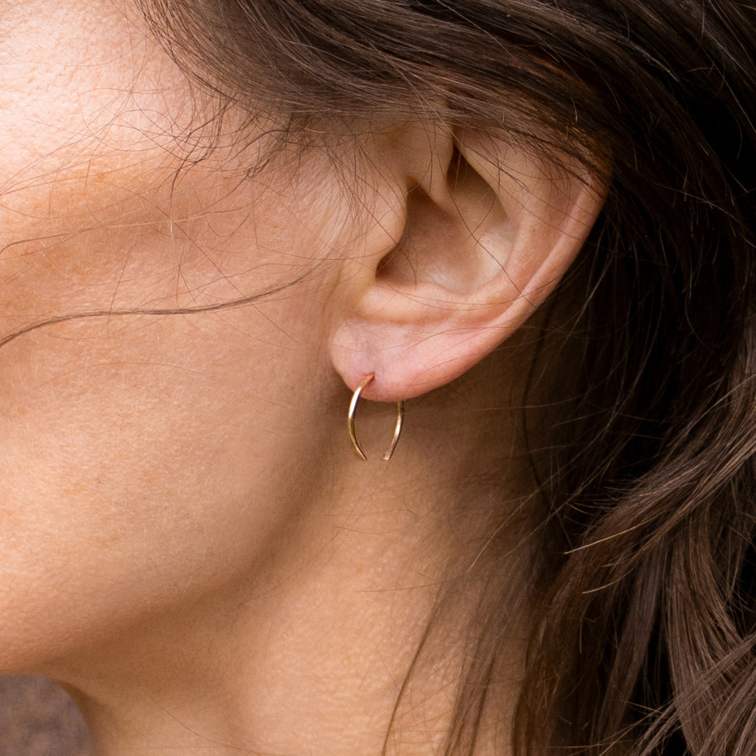 Solid reclaimed 10k gold hammer-finished open hoop earrings measuring 0.75 inches in diameter handmade and finished in our Catskills store-studio shown on model.