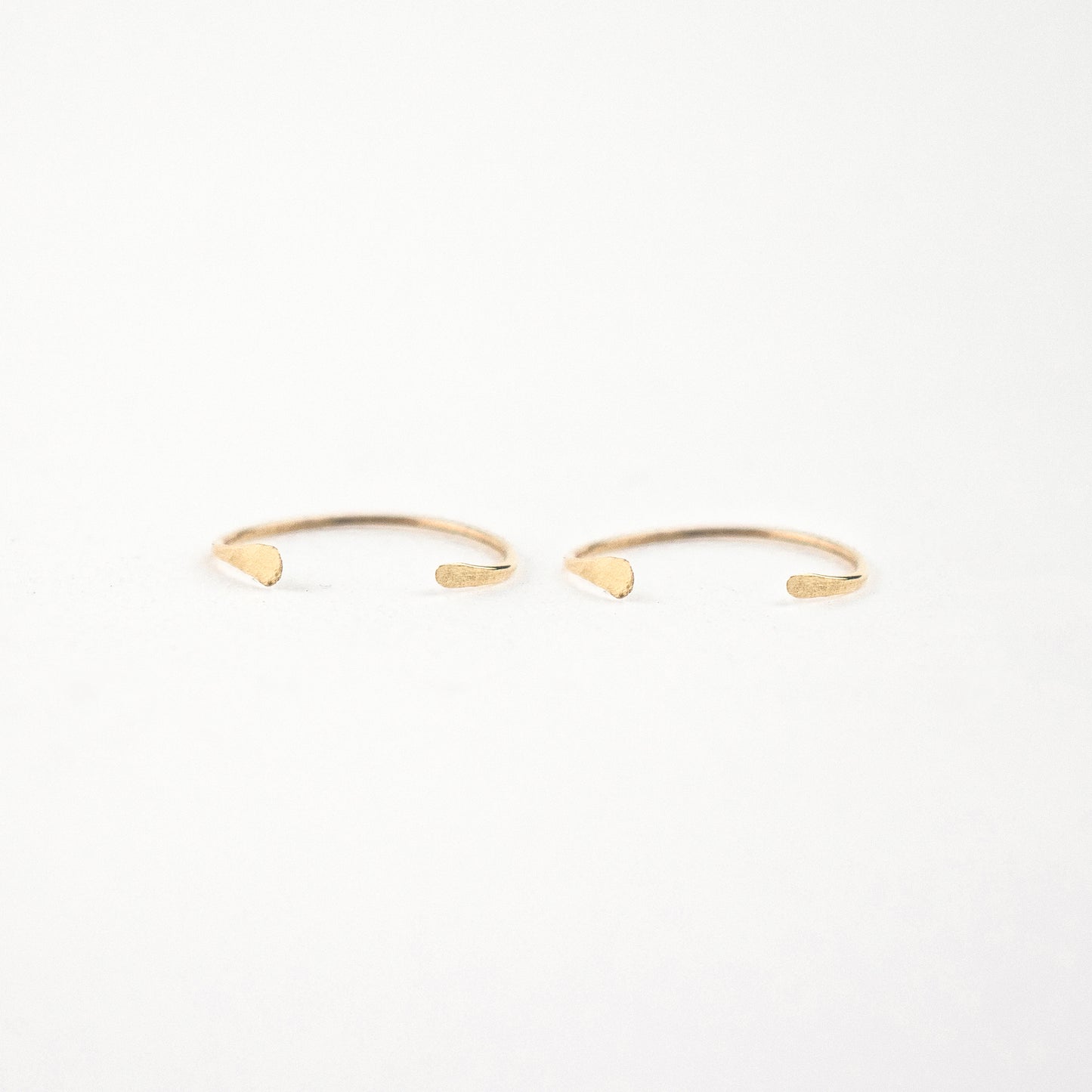 Solid reclaimed 10k gold hammer-finished open hoop earrings measuring 0.75 inches in diameter handmade and finished in our Catskills store-studio.