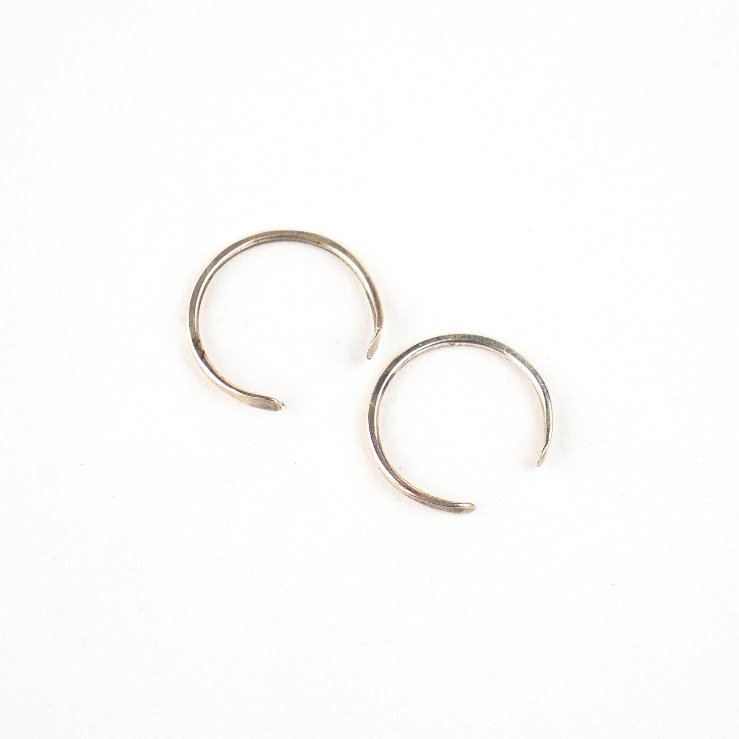 Solid reclaimed sterling silver hammer-finished open hoop earrings measuring 0.75 inches in diameter handmade and finished in our Catskills store-studio.