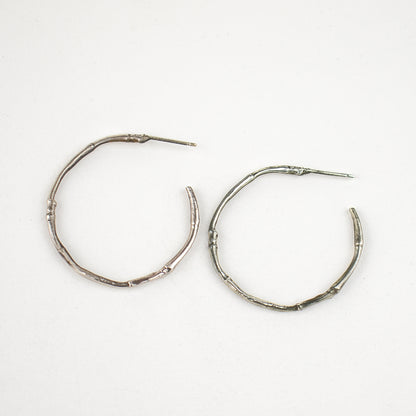 Solid reclaimed sterling silver or brass branch hoop earrings measuring 2 inches in diameter with sterling posts handmade and finished in our Catskills store-studio.