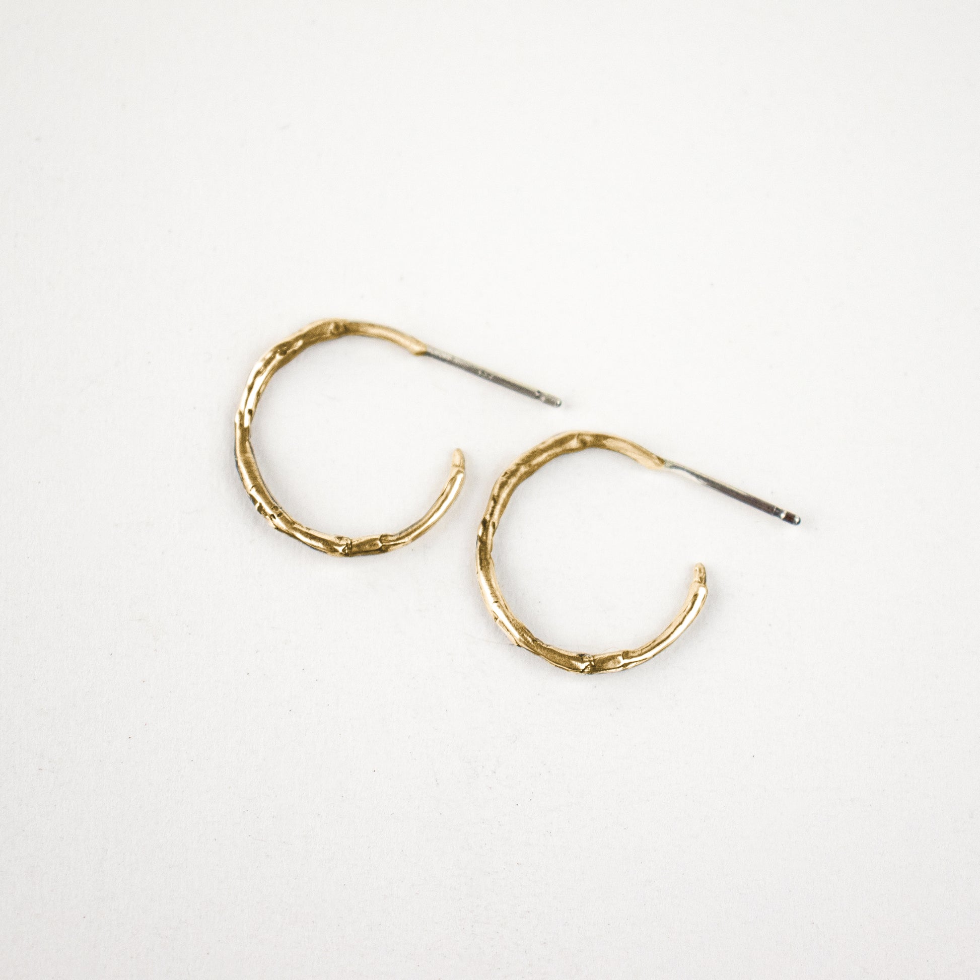 Solid reclaimed 10k gold small branch hoop earrings measuring 1 inch in diameter with sterling posts handmade and finished in our Catskills store-studio.