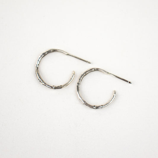 Solid reclaimed sterling silver small branch hoop earrings measuring 1 inch in diameter handmade and finished in our Catskills store-studio.