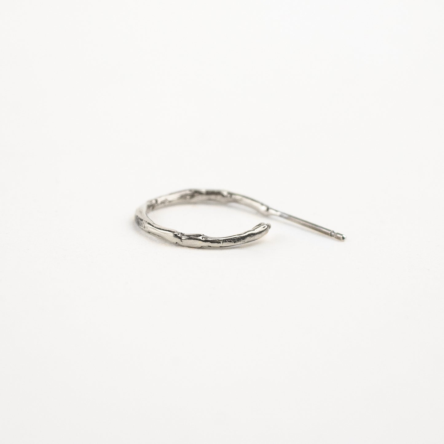 Solid reclaimed sterling silver small branch hoop earrings measuring 1 inch in diameter handmade and finished in our Catskills store-studio.