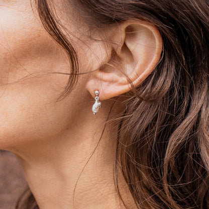 Reclaimed sterling silver stud earrings with three hand-beaded freshwater pearl teardrops handmade and finished in our Catskills store-studio shown on model.