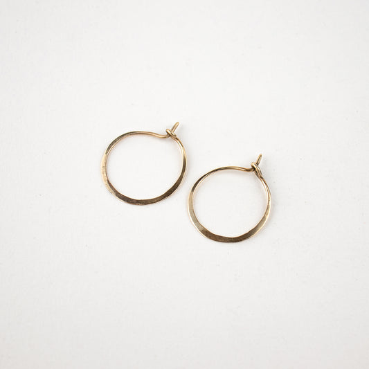 Solid reclaimed 10k gold hammer-finished hoop earrings measuring 1 inch in diameter handmade and finished in our Catskills store-studio.