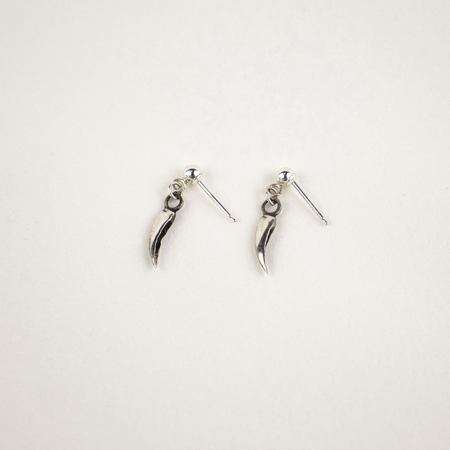 Solid reclaimed sterling silver dangling claw stud earrings handmade and finished in our Catskills store-studio and available as singles to mix-and-match.