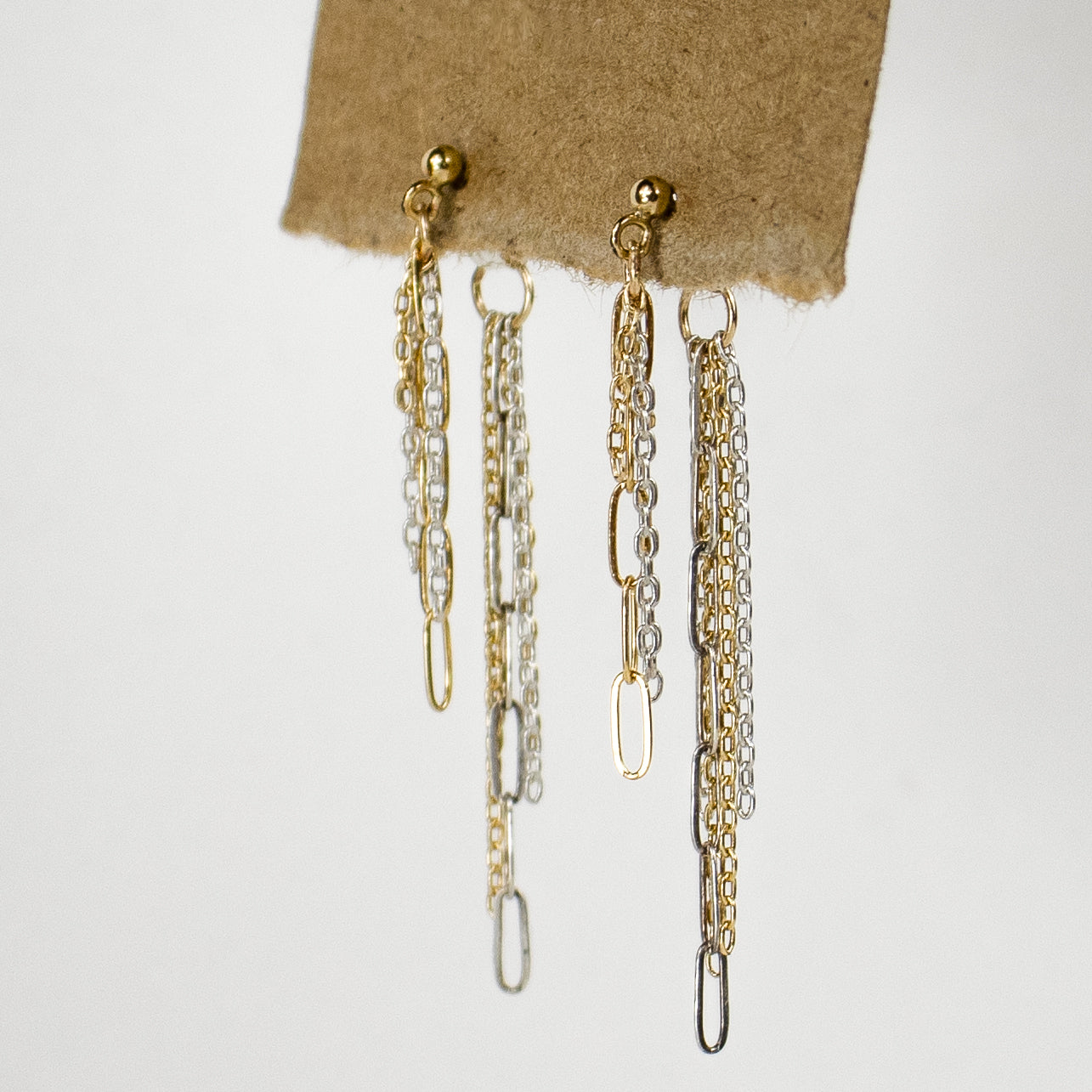 Mixed-length reclaimed sterling silver and gold-filled mixed-chains become double-sided tassels dangling from gold-filled studs and sterling silver backings handmade and finished in our Catskills store-studio and available as singles to mix-and-match.