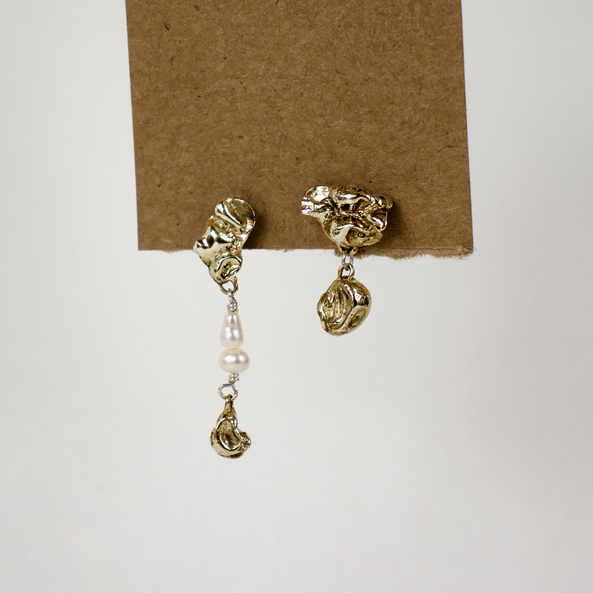 Brass asymmetrical seaweed pods dangling from sterling silver stud earrings beaded with freshwater pearls