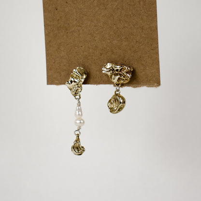 Brass asymmetrical seaweed pods dangling from sterling silver stud earrings beaded with freshwater pearls