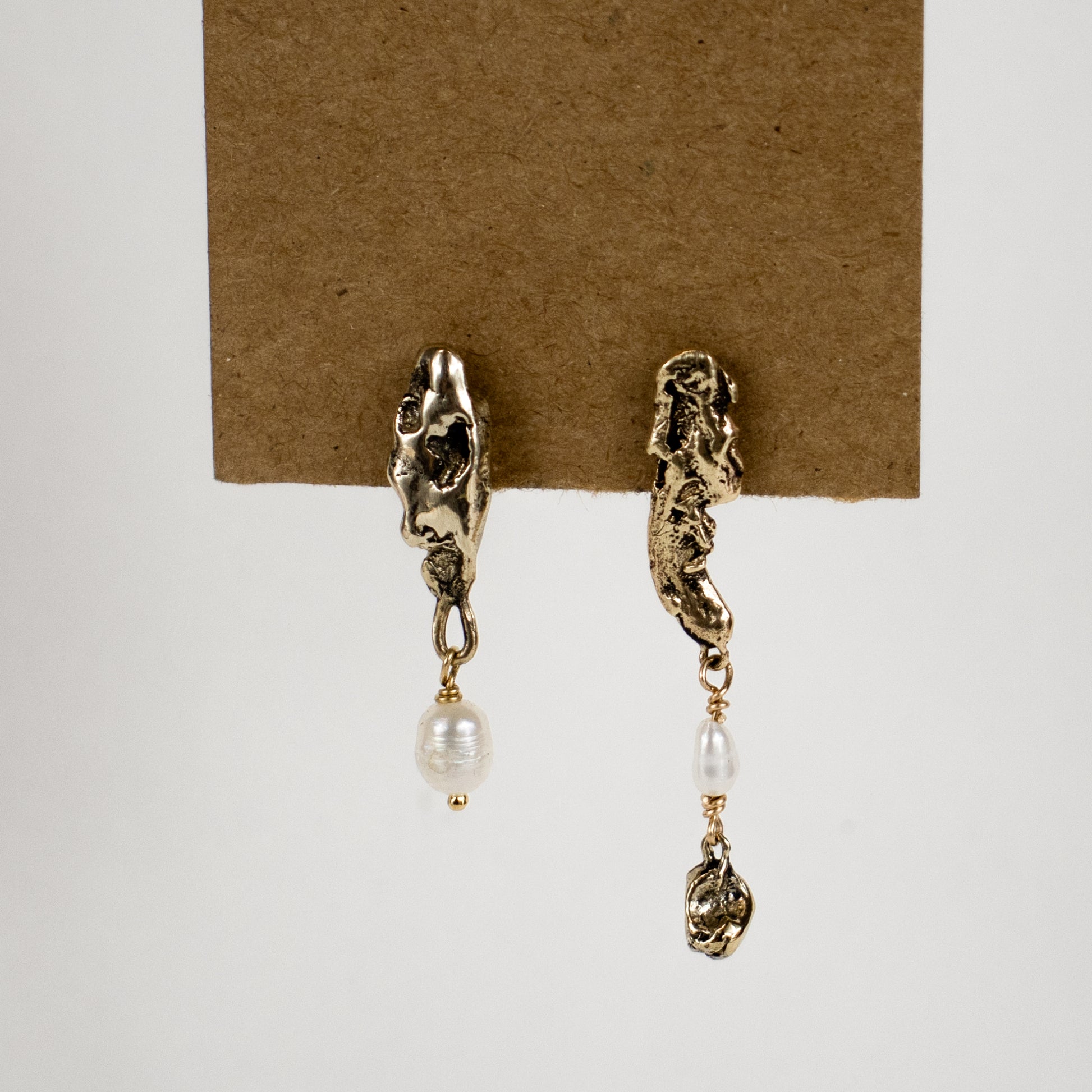 Asymmetrical reclaimed sculptural seaweed pods drop-beaded with freshwater pearls measuring 1.25 and 1.75 inches in length, available in sterling silver or brass handmade and finished in our Catskills store-studio.
