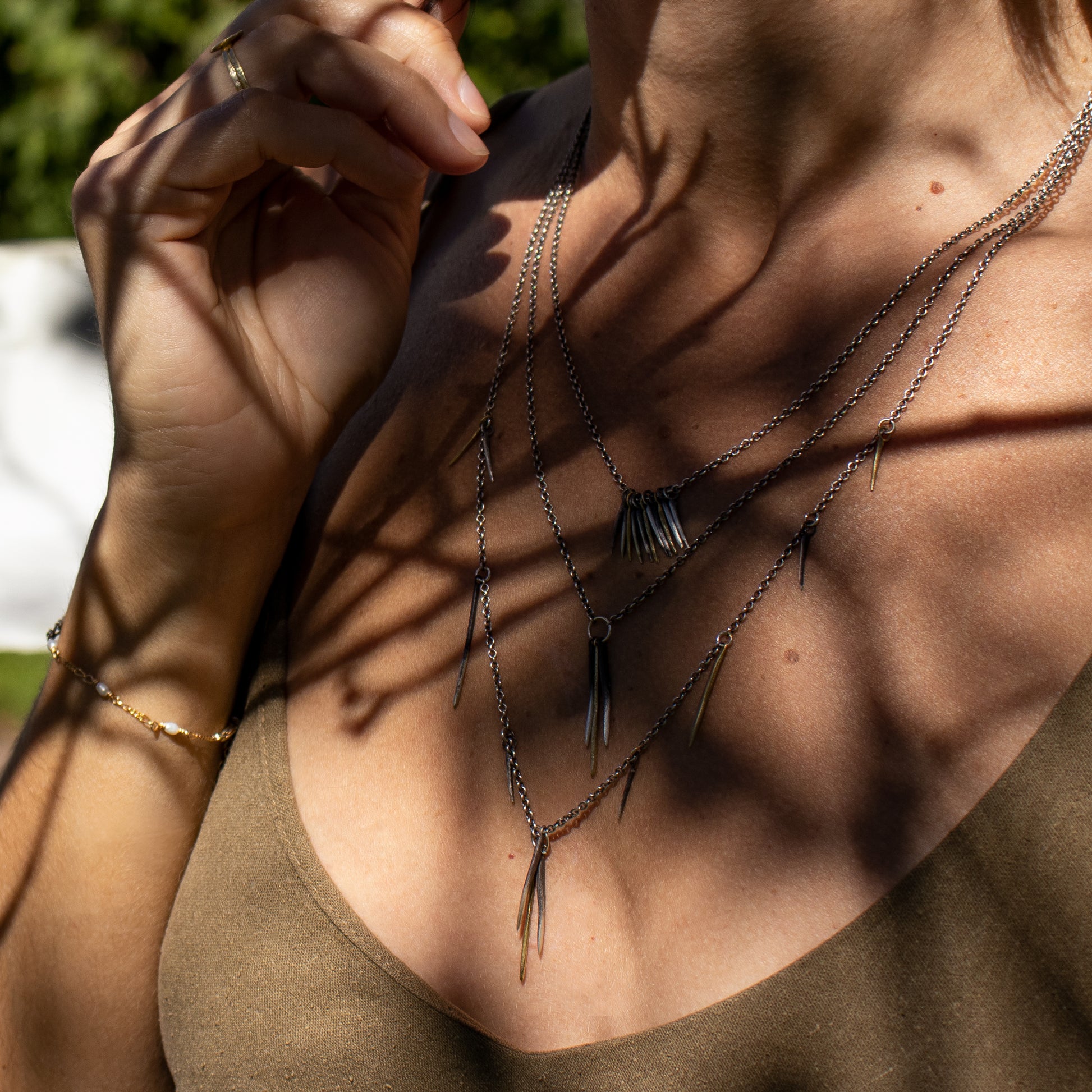 Solid reclaimed 10k gold and partially oxidized sterling silver snake spikes on sterling cable-chain adjustable 18 - 22 inches handmade and finished in our Catskills store-studio shown on model.