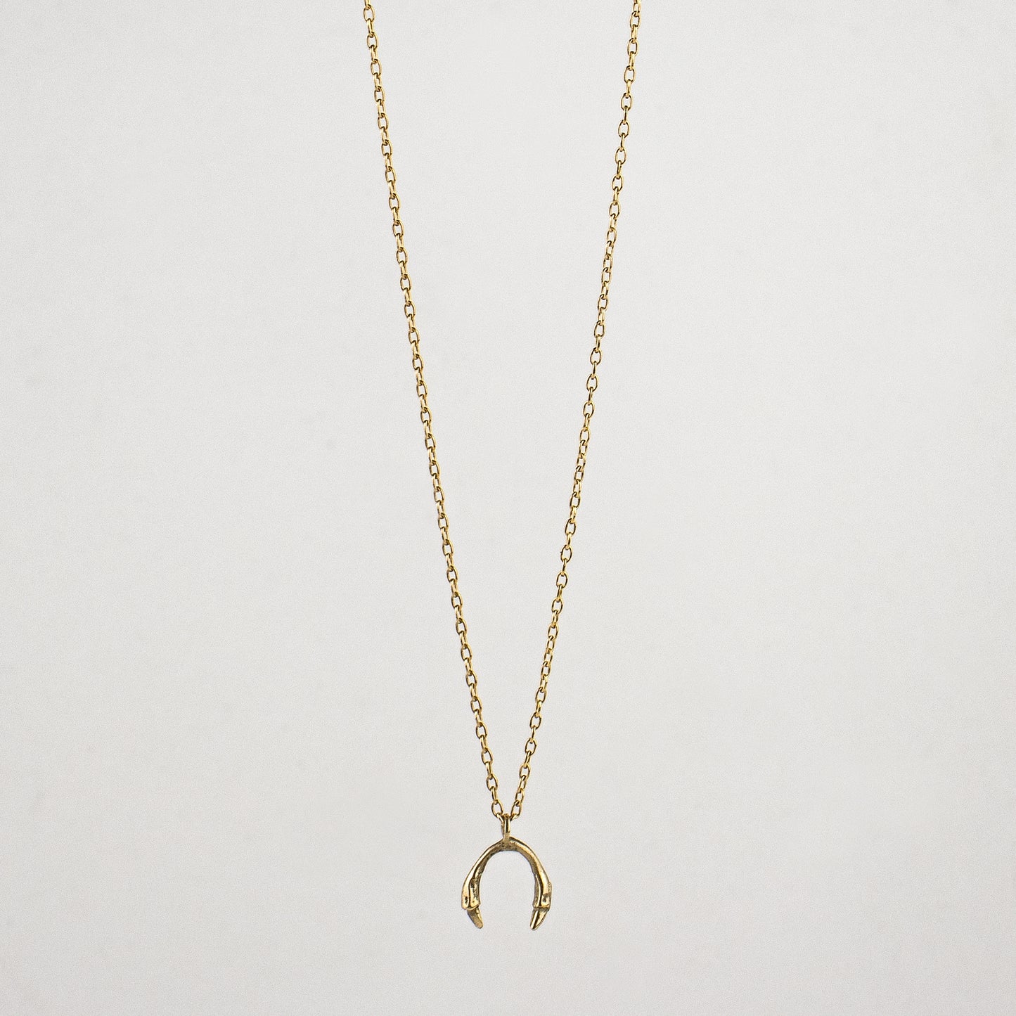 Tiny horseshoe pendant measuring 0.25" available in Solid reclaimed 10k gold or sterling silver tiny 0.25 inch horseshoe pendant on 18 inch gold-filled or sterling fine-chain handmade and finished in our Catskills store-studio.