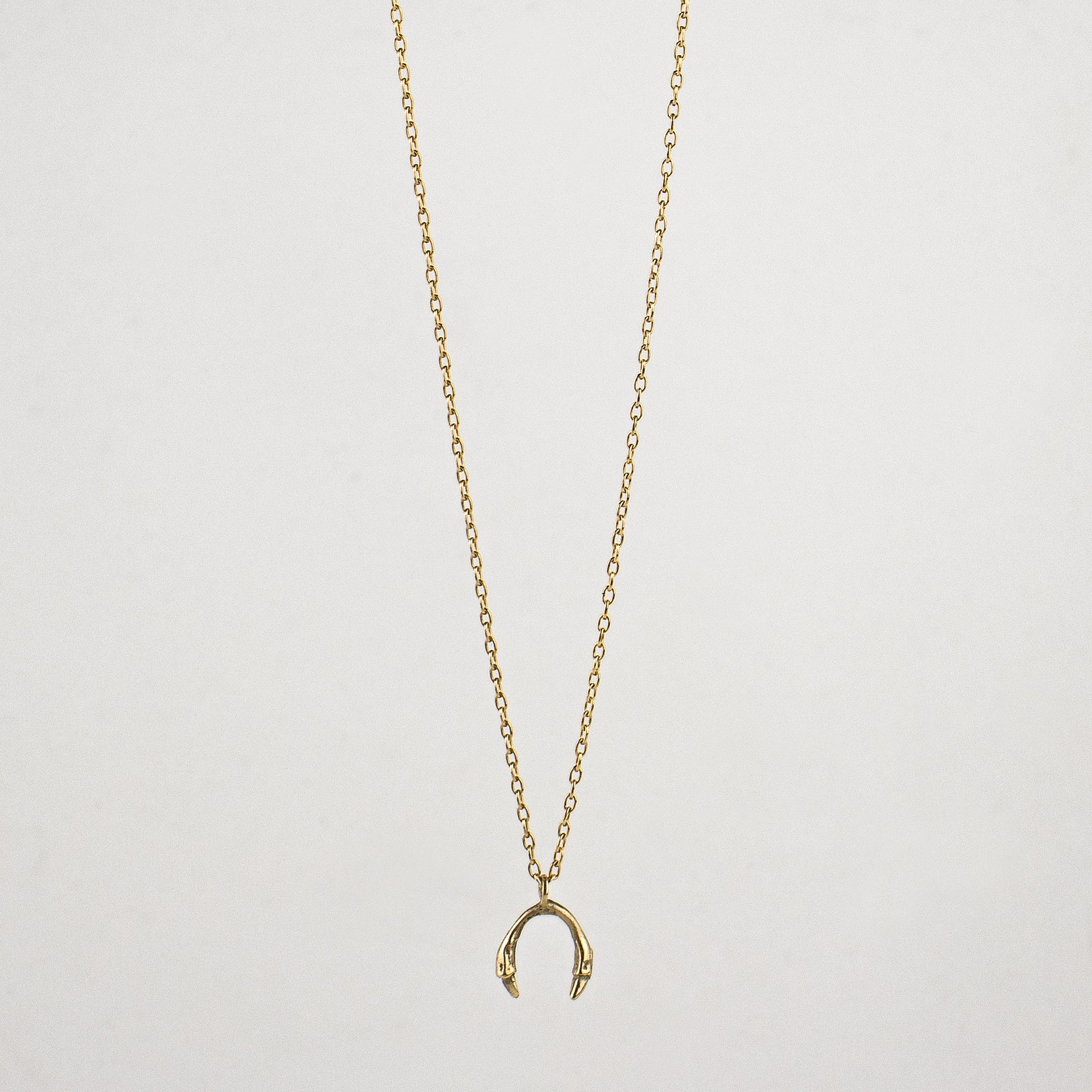 Tiny horseshoe pendant measuring 0.25" available in Solid reclaimed 10k gold or sterling silver tiny 0.25 inch horseshoe pendant on 18 inch gold-filled or sterling fine-chain handmade and finished in our Catskills store-studio.