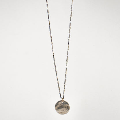 Your choice of solid reclaimed 10k gold or sterling silver hammer-finished shell pendant 0.75 inches in diameter on sterling Figaro chain adjustable 18 - 22 inches and handmade and finished in our Catskills store-studio.