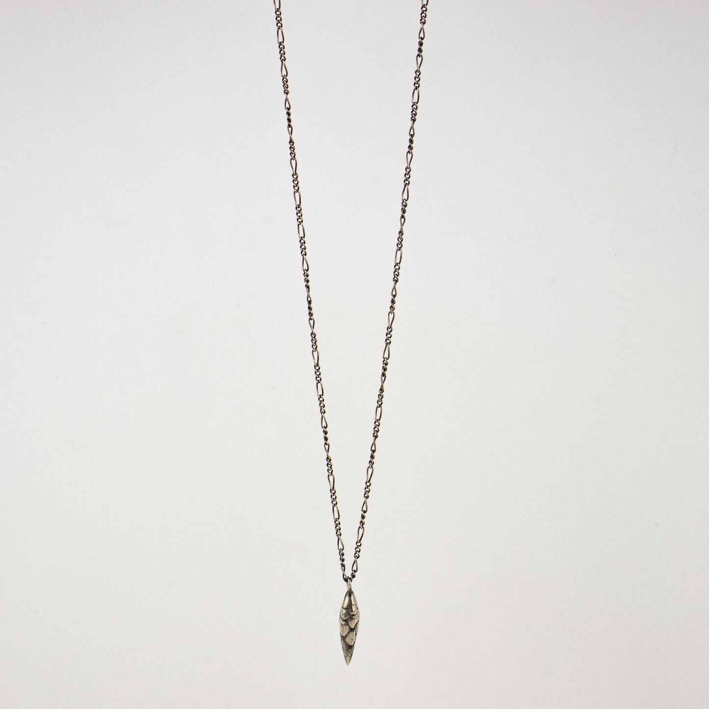 Your choice of solid reclaimed 10k gold or sterling silver bud 0.75 inches in length on sterling Figaro chain adjustable 18 - 22 inches and handmade and finished in our Catskills store-studio.