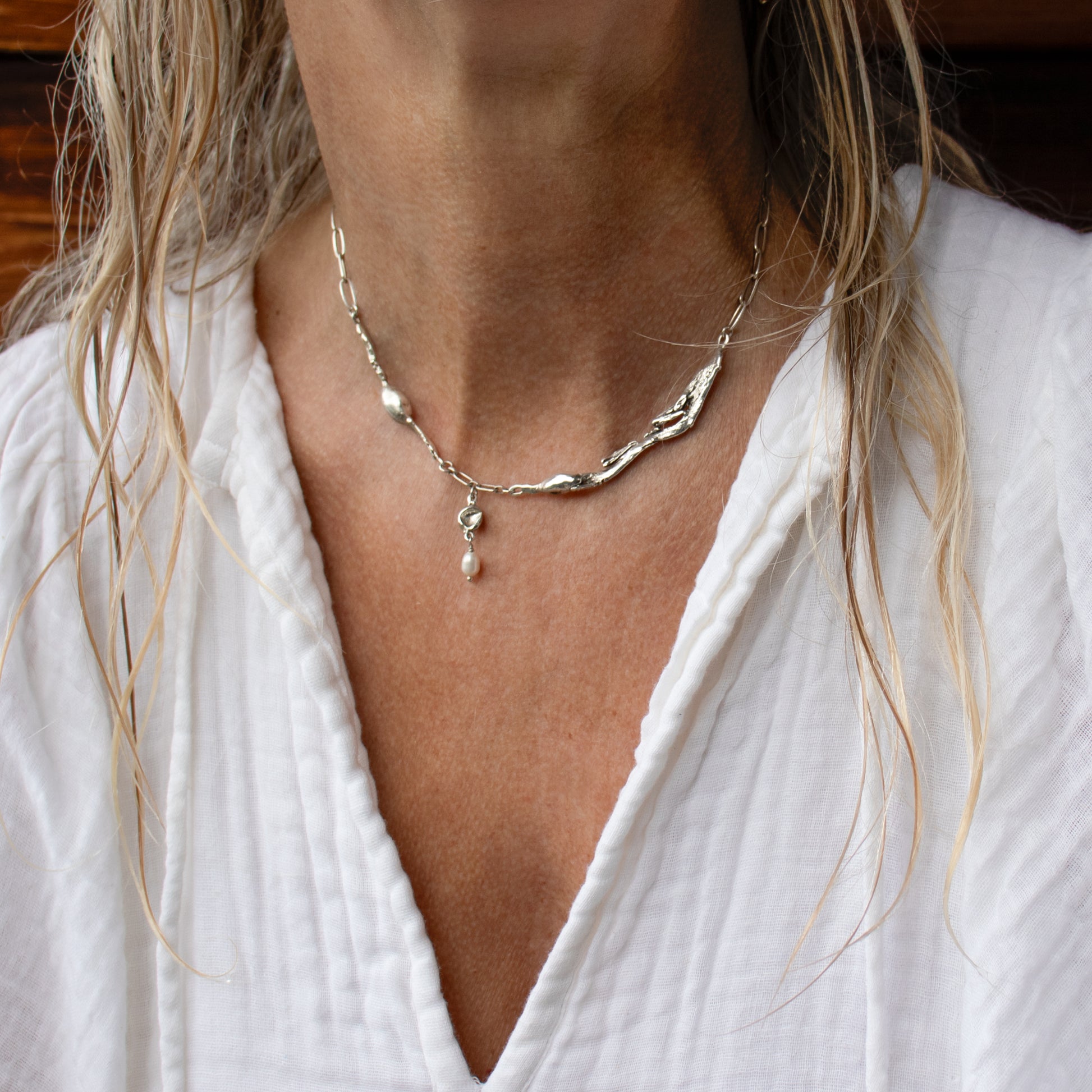 Reclaimed sterling silver seaweed feather and pods with 3 mm freshwater pearl on sterling paperclip chain adjustable 16-18 inches handmade and finished in our Catskills store-studio shown on model.