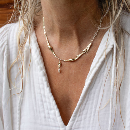 Reclaimed brass seaweed feather and pods with 3 mm freshwater pearl on sterling silver paperclip chain adjustable 16-18 inches handmade and finished in our Catskills store-studio shown on model.