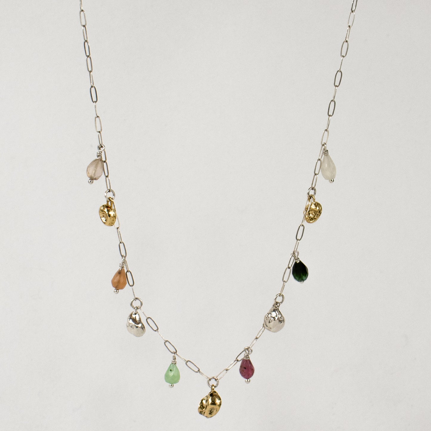 Five reclaimed brass seaweed pods 5 mm each and six 4 mm multicolor beads on fine sterling paperclip chain adjustable 16-18 inches handmade and finished in our Catskills store-studio.