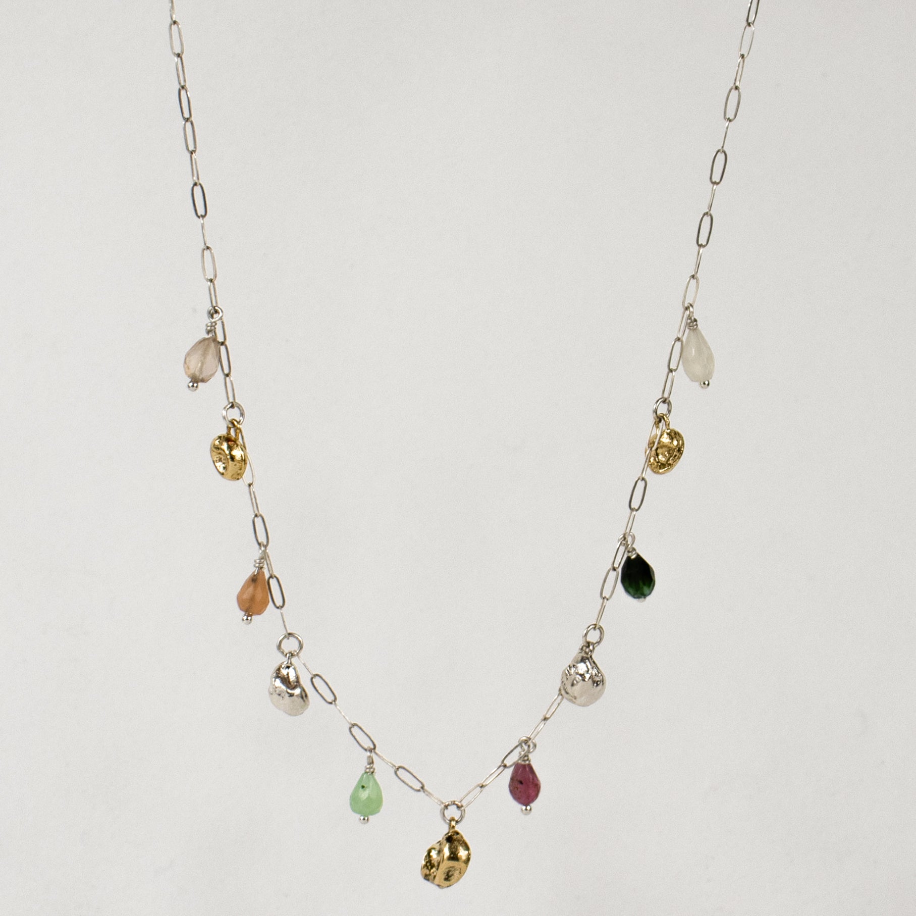 Five reclaimed brass seaweed pods 5 mm each and six 4 mm multicolor beads on fine sterling paperclip chain adjustable 16-18 inches handmade and finished in our Catskills store-studio.