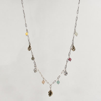 Five reclaimed brass seaweed pods, each measuring 5 mm, and six 4 mm multicolor beads on a fine sterling silver paperclip chain. Adjustable from 16–18 inches. Handmade and finished in our Catskills store-studio.