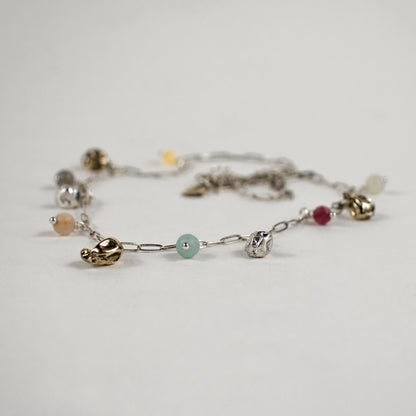 Five reclaimed brass seaweed pods, each measuring 5 mm, and six 4 mm multicolor beads on a fine sterling silver paperclip chain. Adjustable from 16–18 inches. Handmade and finished in our Catskills store-studio.