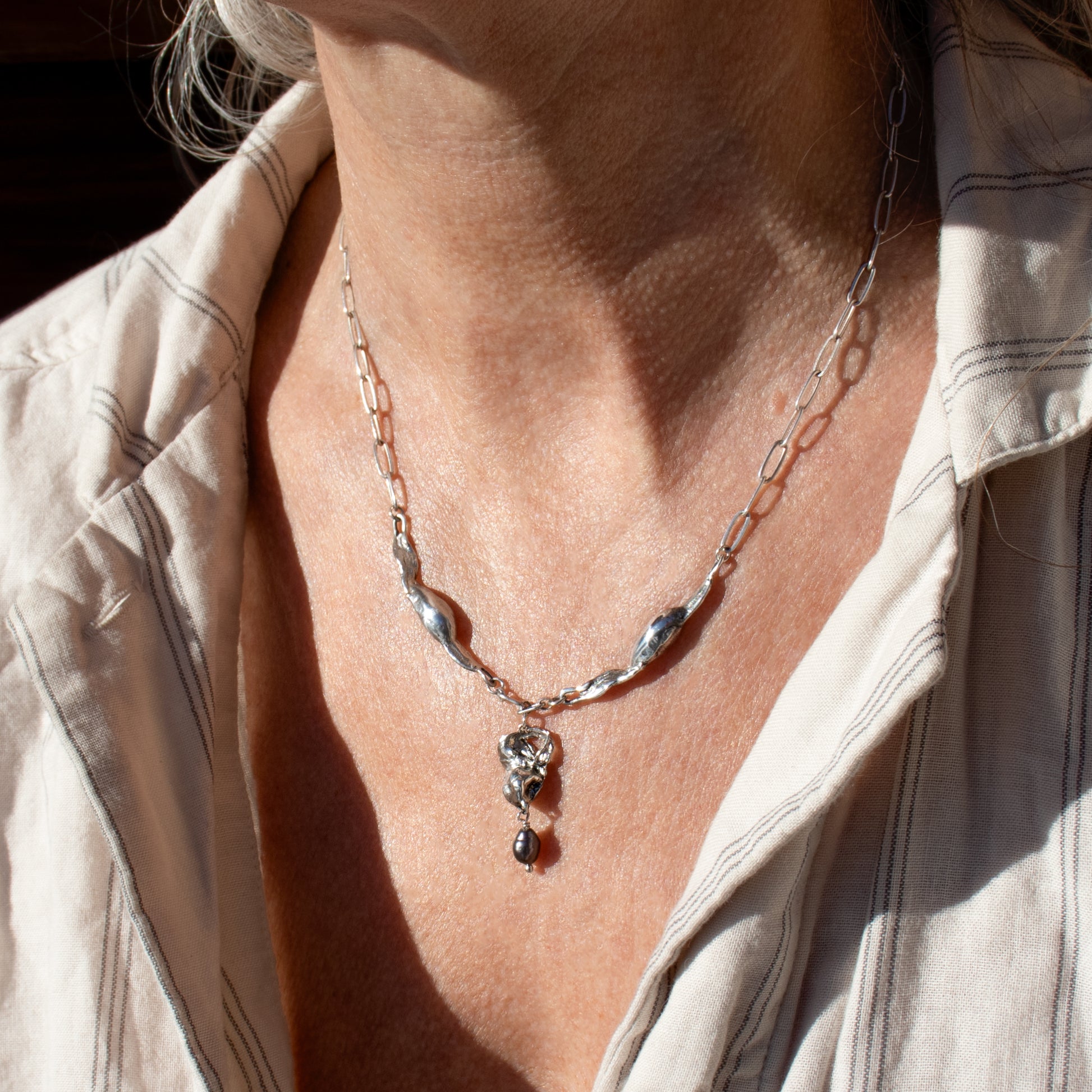 Reclaimed sterling silver seaweed feathers and pod pendant with 3 mm black pearl on sterling paperclip chain adjustable 16-18 inches handmade and finished in our Catskills store-studio.