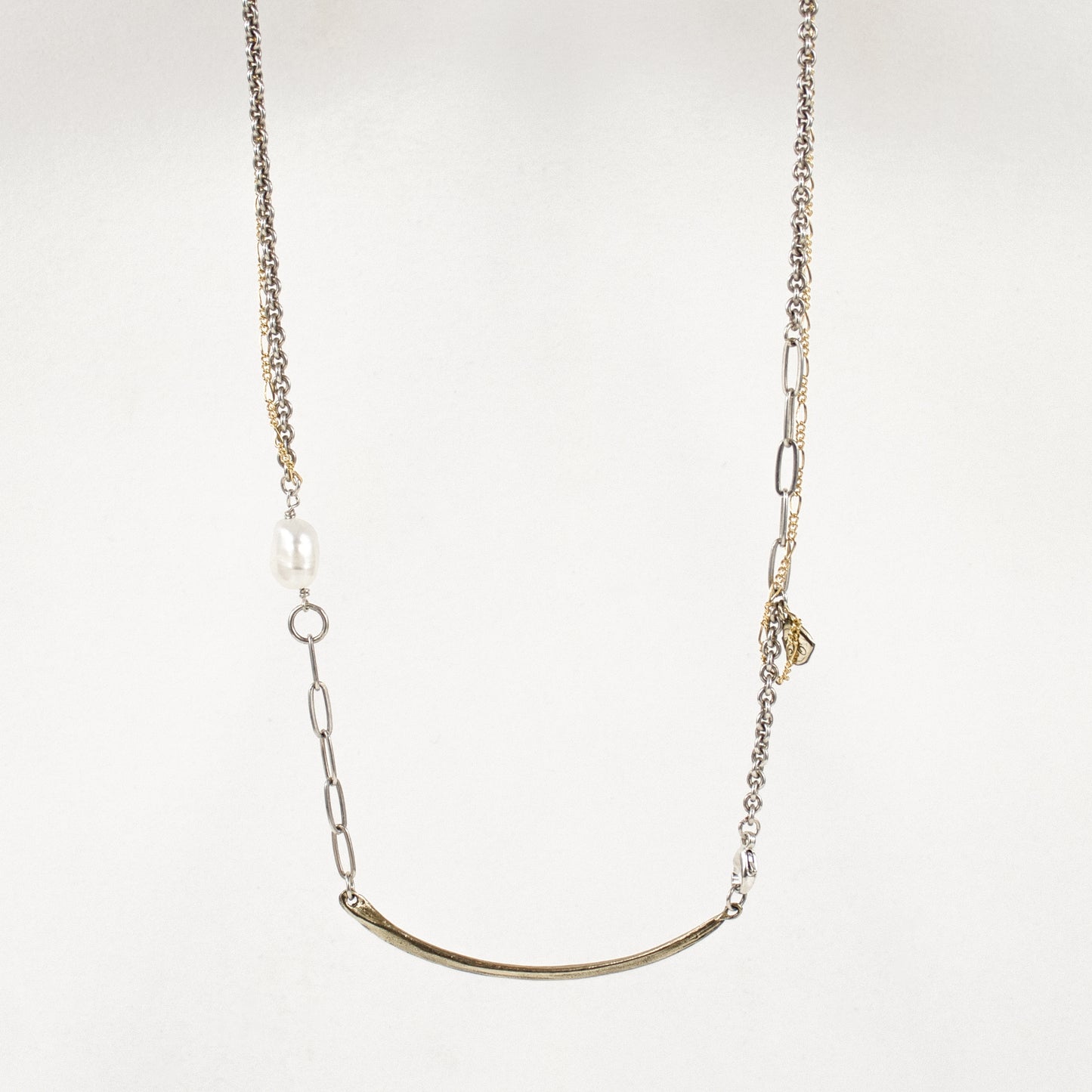 Reclaimed 2 inch arc pendant available in sterling silver or brass on 16 inch sterling and gold-filled mixed-chain hand-beaded with a freshwater pearl handmade and finished in our Catskills store-studio