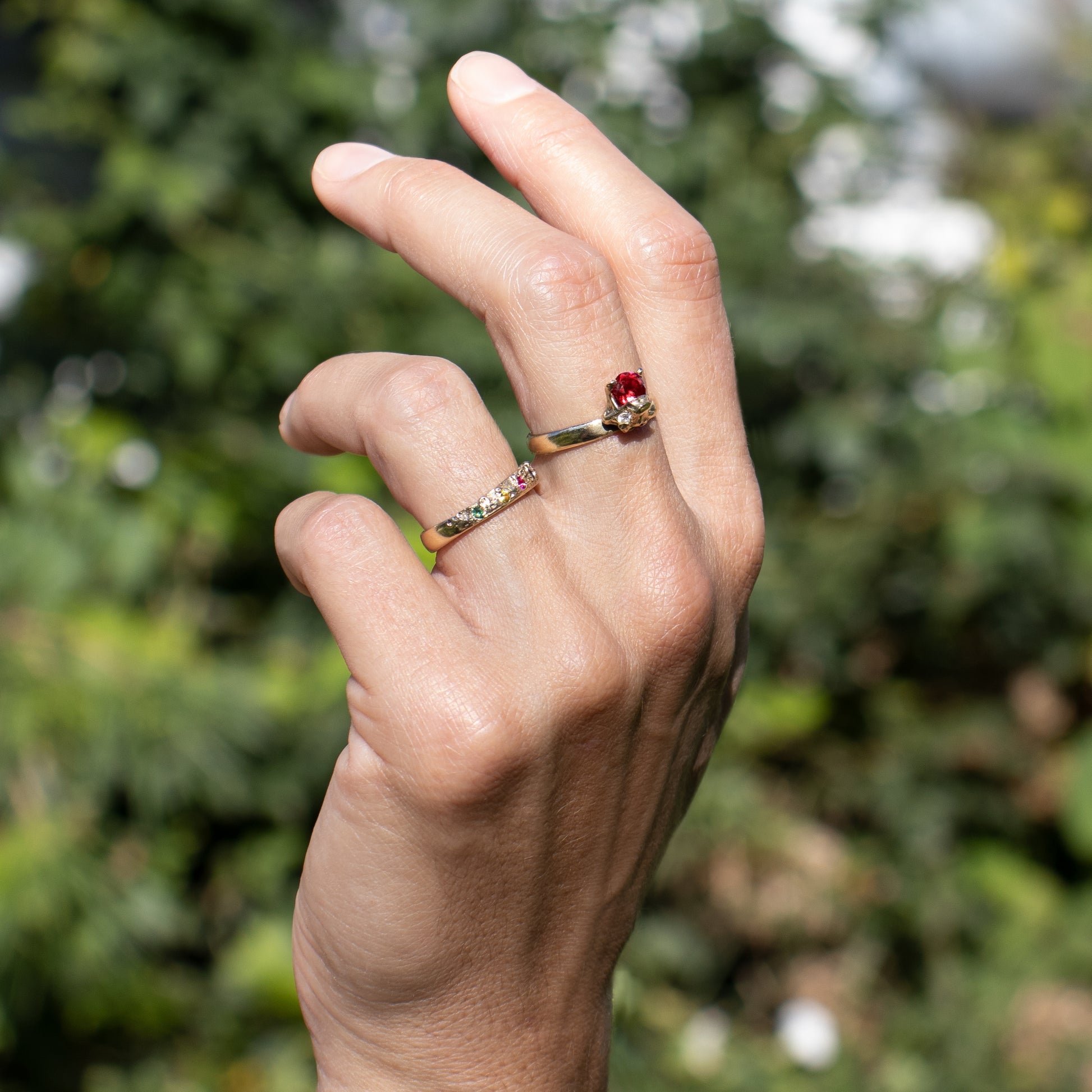 Solid reclaimed 14k gold vertebrae Crown ring with a single 5 mm ruby and two 2 mm diamonds all in natural settings with a band-width of 2.5 mm made-to-order and finished in our Catskills store-studio shown on model with wedding band.