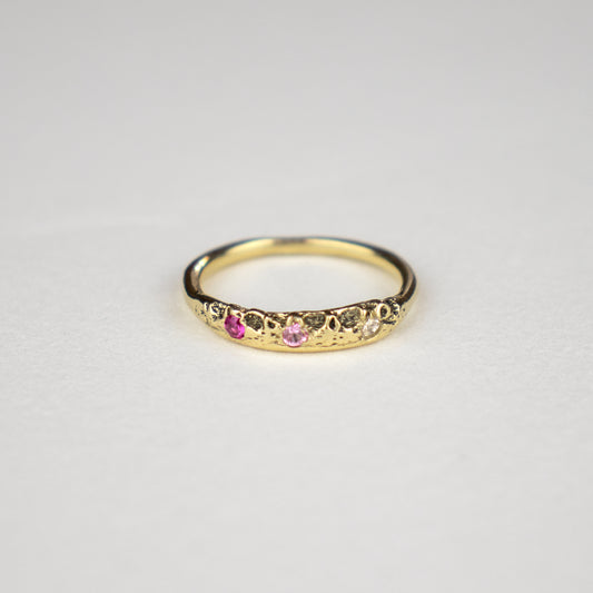 Solid reclaimed 14k gold Vomer ring with a 3 - 3.5 mm band-width set with two 2mm pink sapphires and a 2mm diamond.