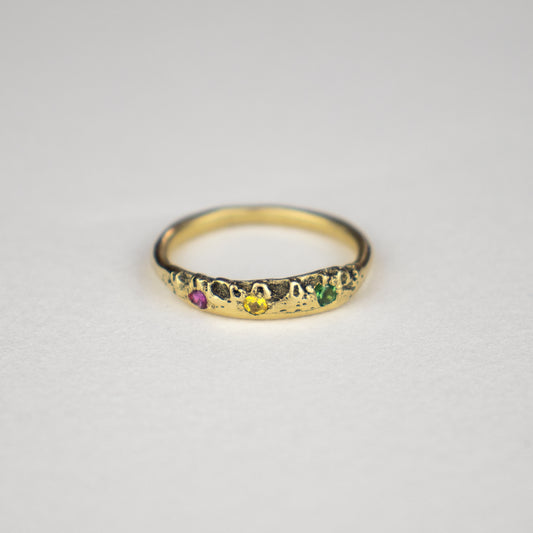 Solid reclaimed 14k gold Vomer ring with a 3 - 3.5 mm band-width set with three 2 mm pink, yellow, and green sapphires.