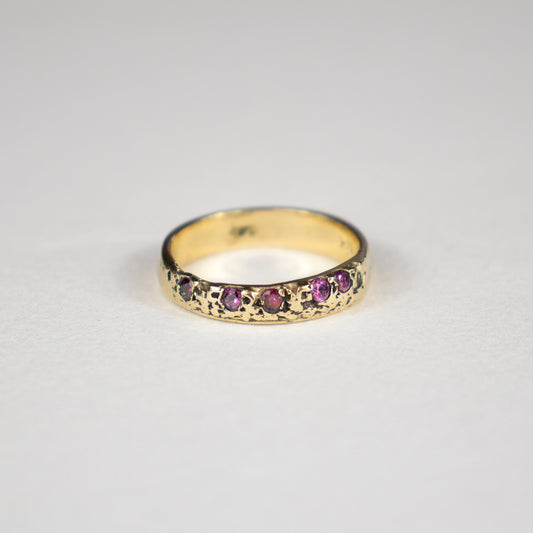Solid reclaimed 14k gold Vomer ring with a 4mm band-width set with five 2 mm hot pink sapphires.