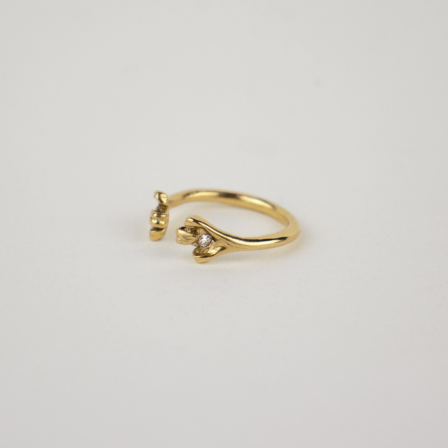 Solid reclaimed 14k gold femur ring set with two 2mm diamonds and adjustable for ring sizes 5 to 6.5 made-to-order and finished in our Catskills store-studio.