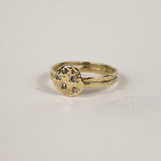 Solid reclaimed 14k gold hammer-finished Maine rock ring set with one 2 mm champagne, two 1.5 mm champagne and two 1.5 mm salt and pepper diamonds with ring face 0.5 inch in diameter.