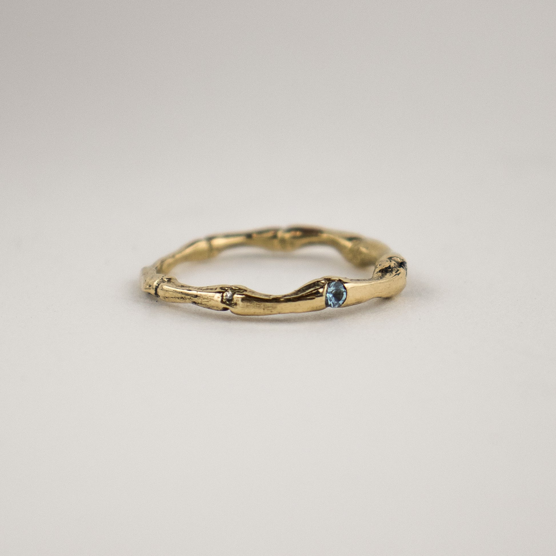 Solid reclaimed 14k gold muskrat spine ring set with two 2mm blue sapphires and a 2mm diamond.  Made-to-order and finished in our Catskills store-studio.