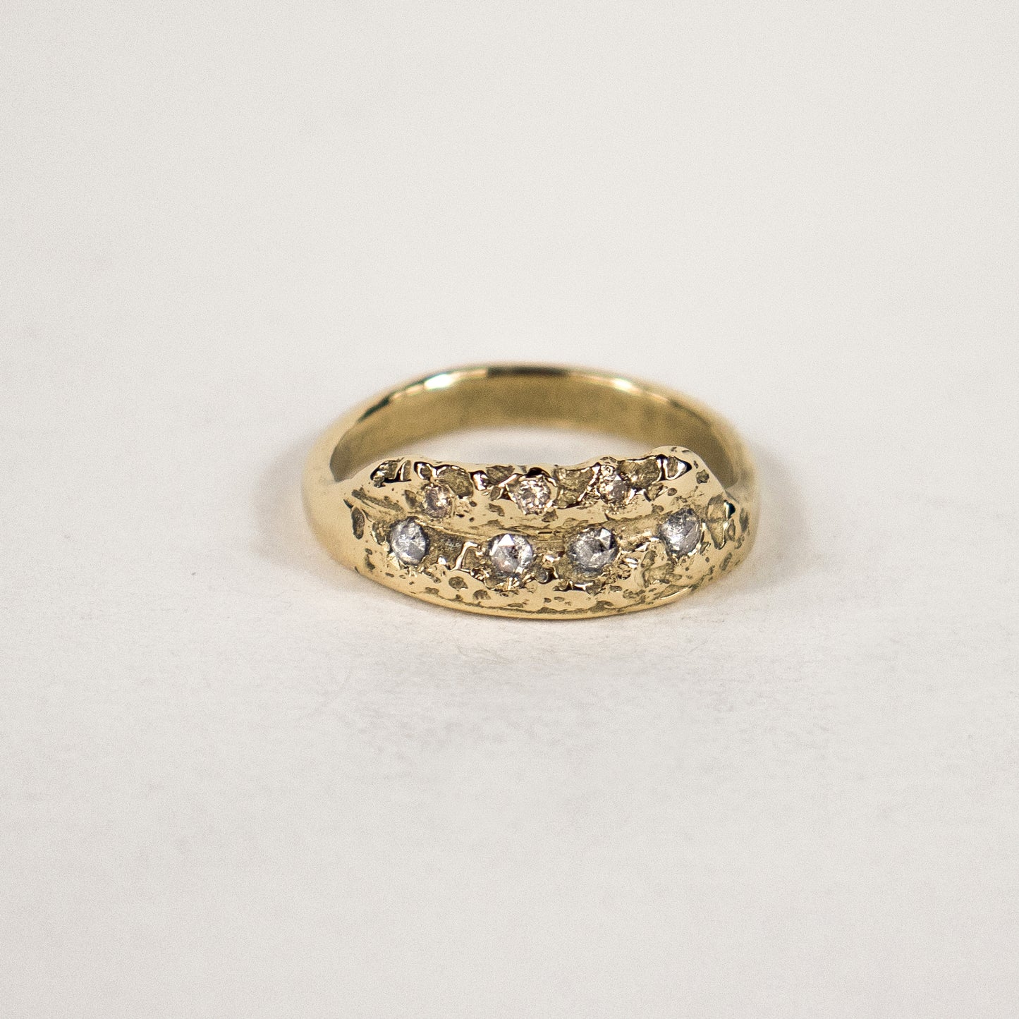 The Vomer bone of a fish jaw provides unique natural settings for this solid reclaimed 14k gold "statement ring" set with four 2 mm salt and pepper and three 1 mm champagne diamonds handmade and finished in our Catskills store-studio.