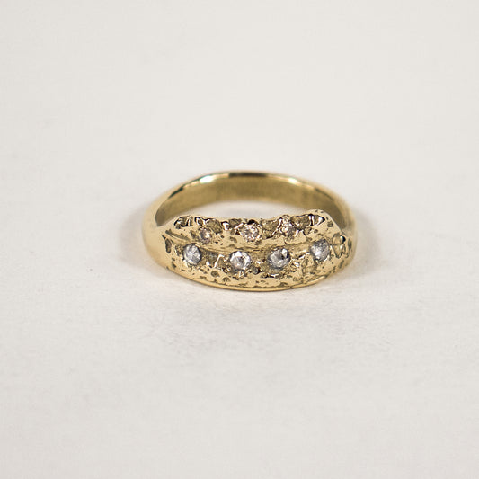 The Vomer bone of a fish jaw provides unique natural settings for this solid reclaimed 14k gold "statement ring" set with four 2 mm salt and pepper and three 1 mm champagne diamonds handmade and finished in our Catskills store-studio.