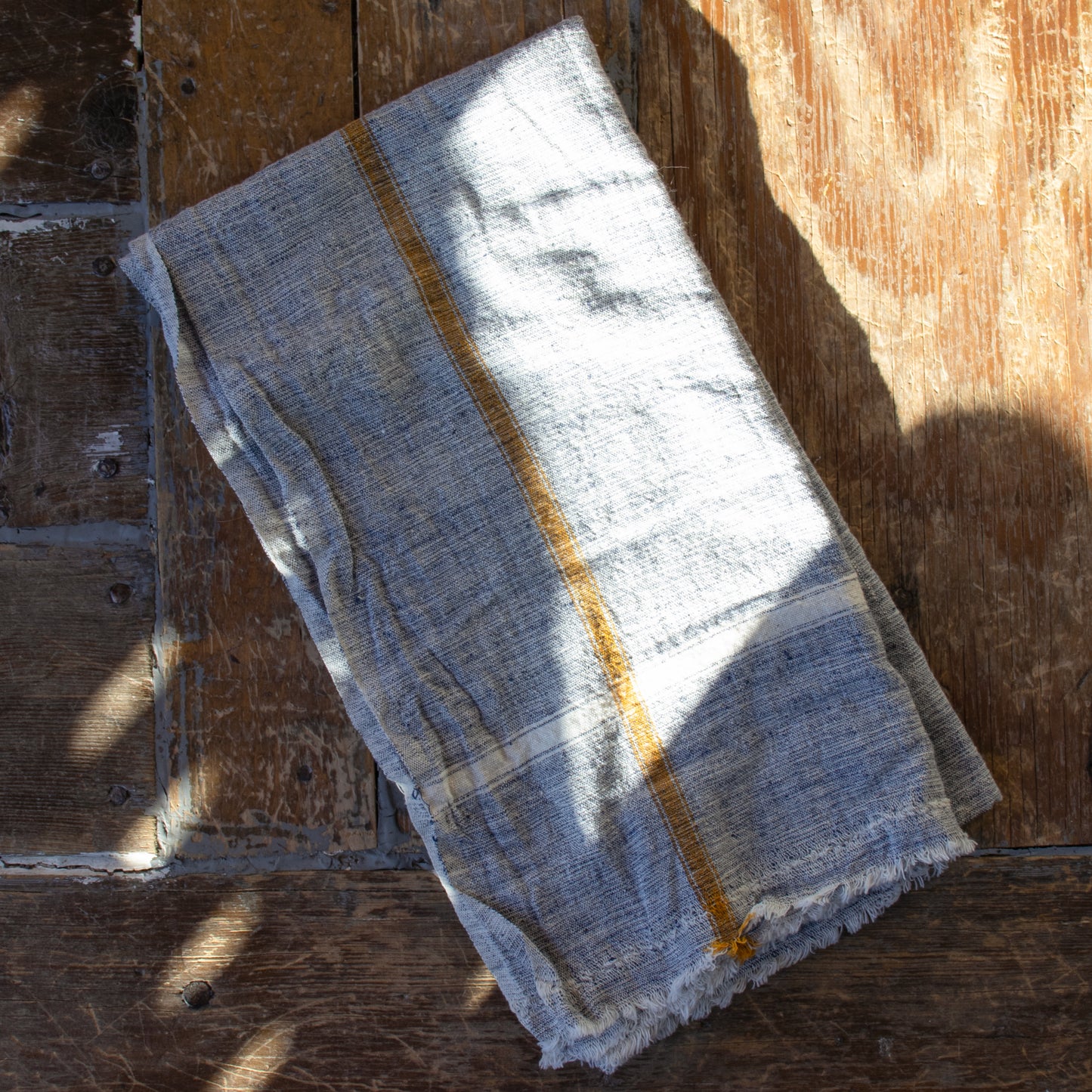 Indian 100% cotton khadi towels—a fabric woven by hand of hand-spun yarn available in your choice of pale blue or green with color pinstripe accents shown and measuring 31 x 56 inches overall.