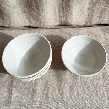 Each Palo Santo bowl is hand-thrown on the wheel and slightly unique with the intention of bringing calm to your table or surroundings. Featured in a salt, cool off-white color and measuring approximately 2.25 inches in height and 4.5 inches in width.