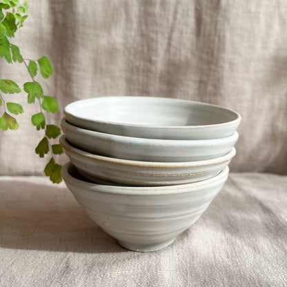 Each Palo Santo bowl is hand-thrown on the wheel and slightly unique with the intention of bringing calm to your table or surroundings. Featured in a salt, cool off-white color and measuring approximately 2.25 inches in height and 4.5 inches in width.