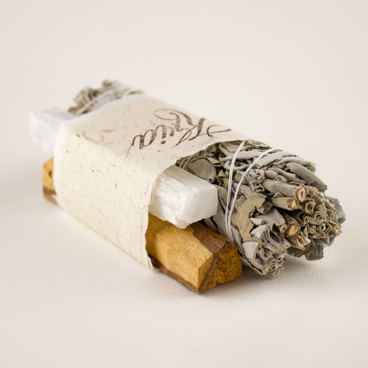 Kria World self-care meditation bundle with an ethically sourced 6 inch hand-tied roll of wild white sage, a 5 inch selenite crystal, and a 5 inch Palo Santo stick certified by SERFOR and wrapped by us in handmade Japanese paper.