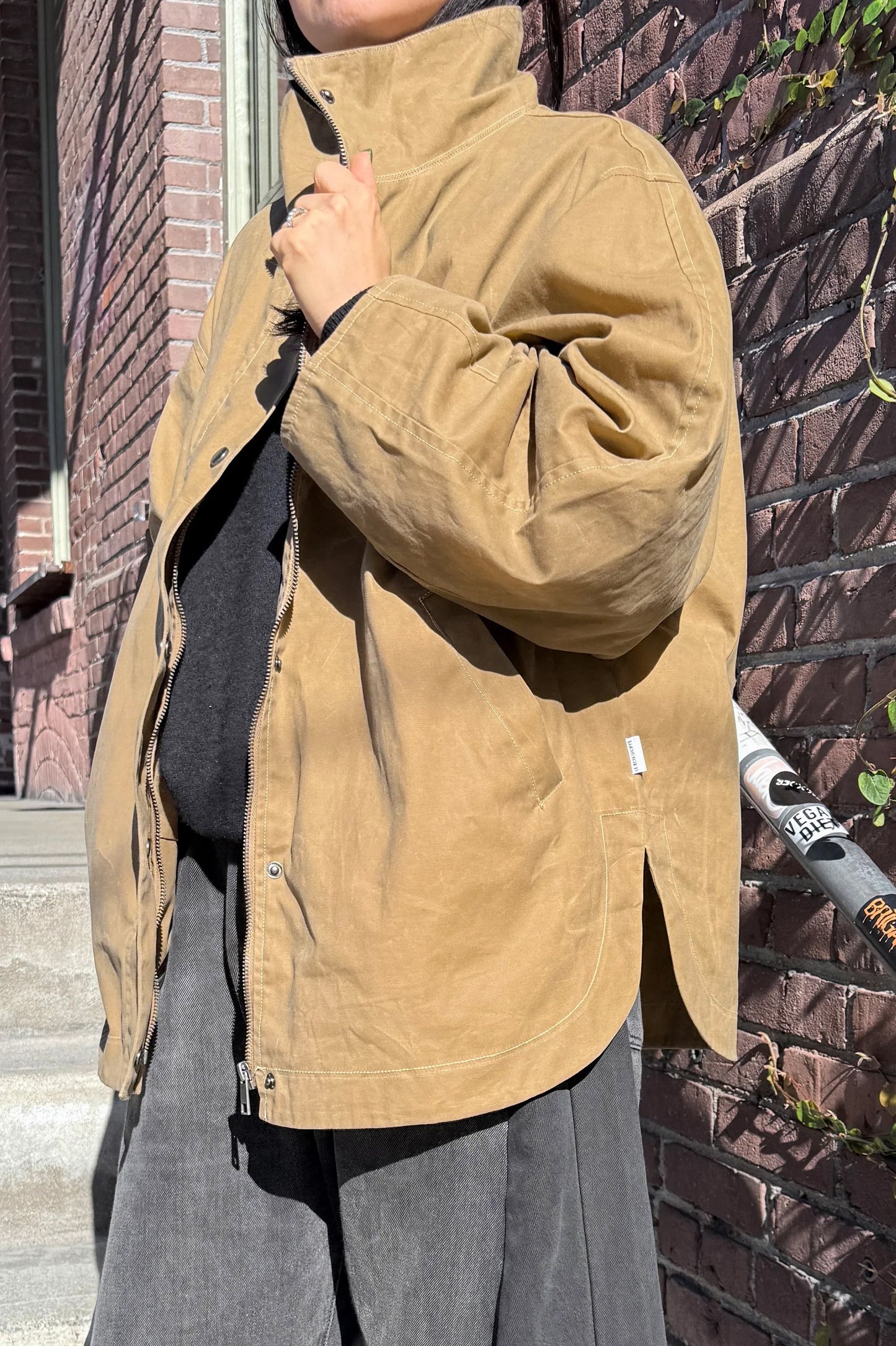 Rain or shine, the Blair fits any wardrobe with a modern silhouette featuring a high funnel neck, roomy barrel sleeves, and a secure zip-and-button front made from durable waxed cotton built to take on light, wet weather.