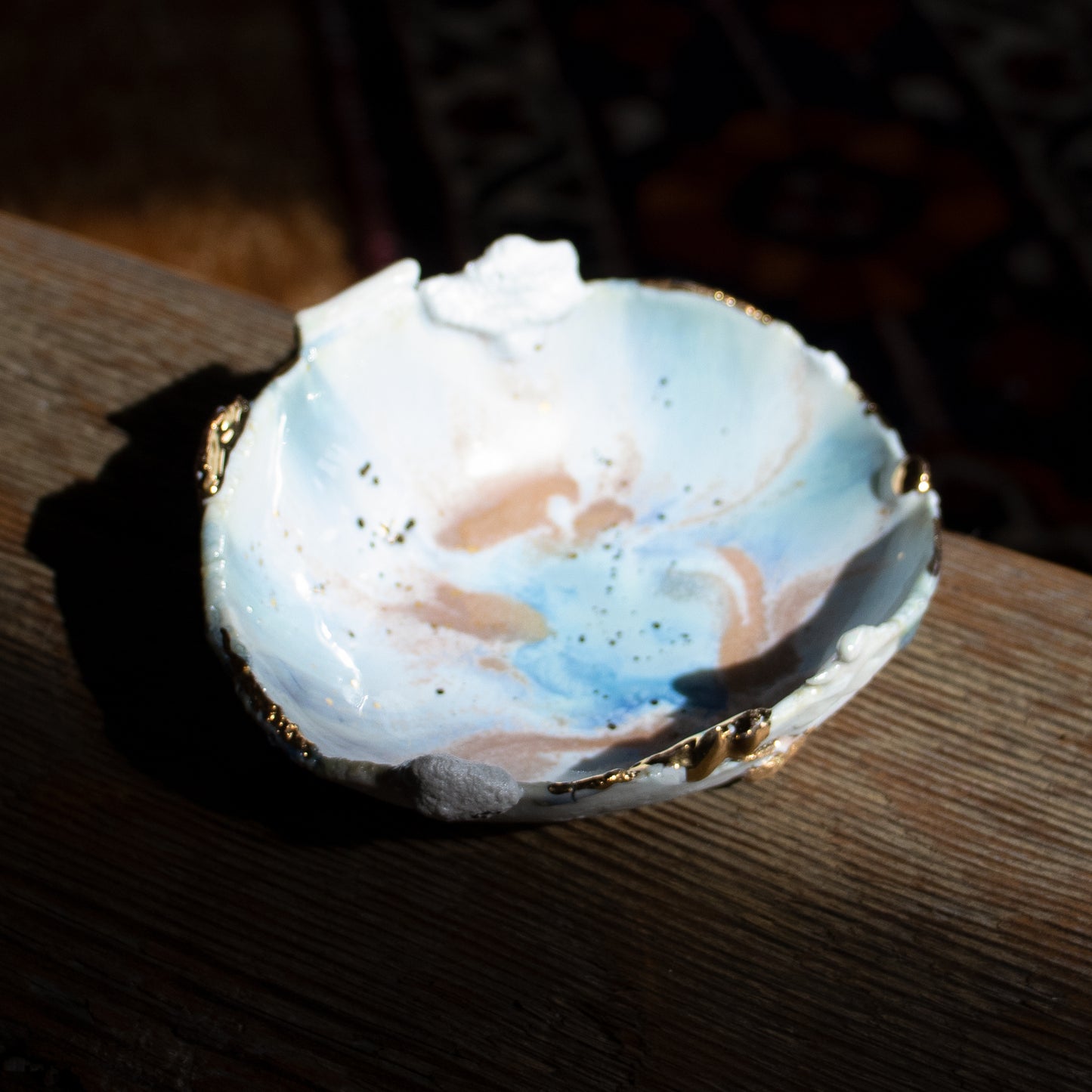 This unique handmade porcelain dish by Minh Singer is inspired by Icelandic geothermal pools and measures approximately 3.75 inches in diameter and 1.25 inches  in height.