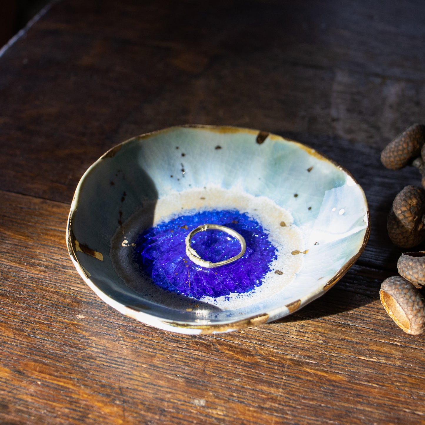 A unique handmade porcelain dish by Minh Singer is inspired by the glacial waterfalls of Iceland and measures 3.5 inches in diameter and 1 inch in height.