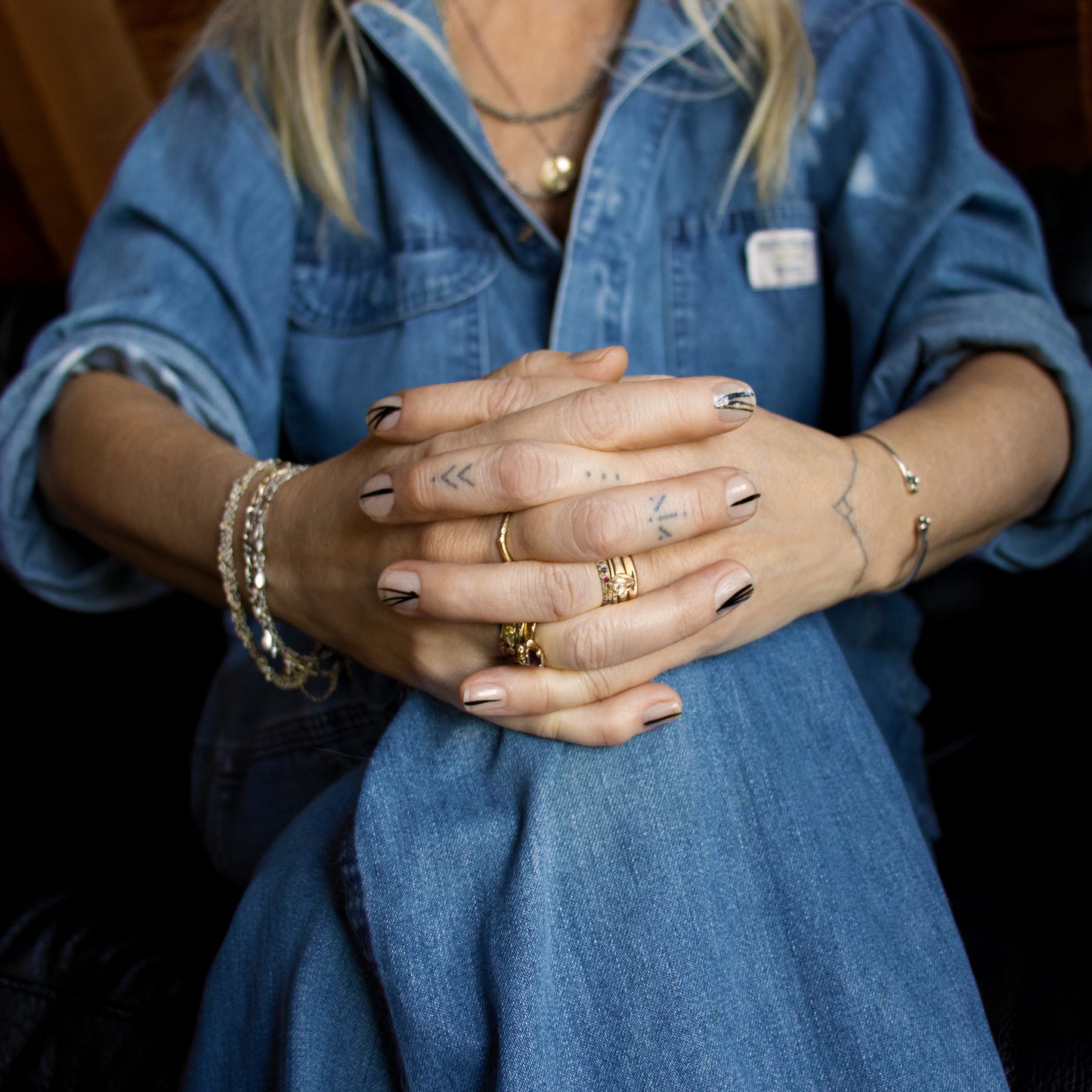 Solid reclaimed 10k gold branch band equally great alone or stacked handmade and finished in our Catskills store-studio shown on model with many rings hands clasped.