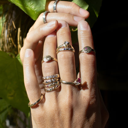 Small solid reclaimed 14k gold Vomer ring with a 3 - 3.5mm band-width set with two 2 mm blue sapphires and one 2 mm diamond.  Made-to-order and finished in our Catskills store-studio shown on model.